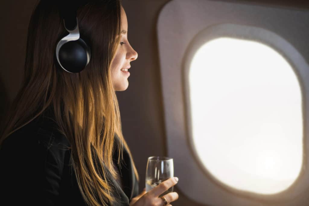 Woman Listening to Music on Airplane