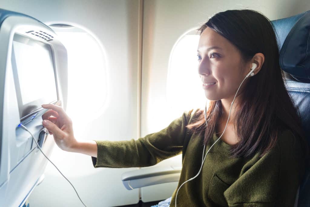 Woman Using In Flight Entertainment System